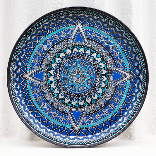 Blue round metal serving tray for ottoman, from Moroccan collection made in blue. Front view on the white background.