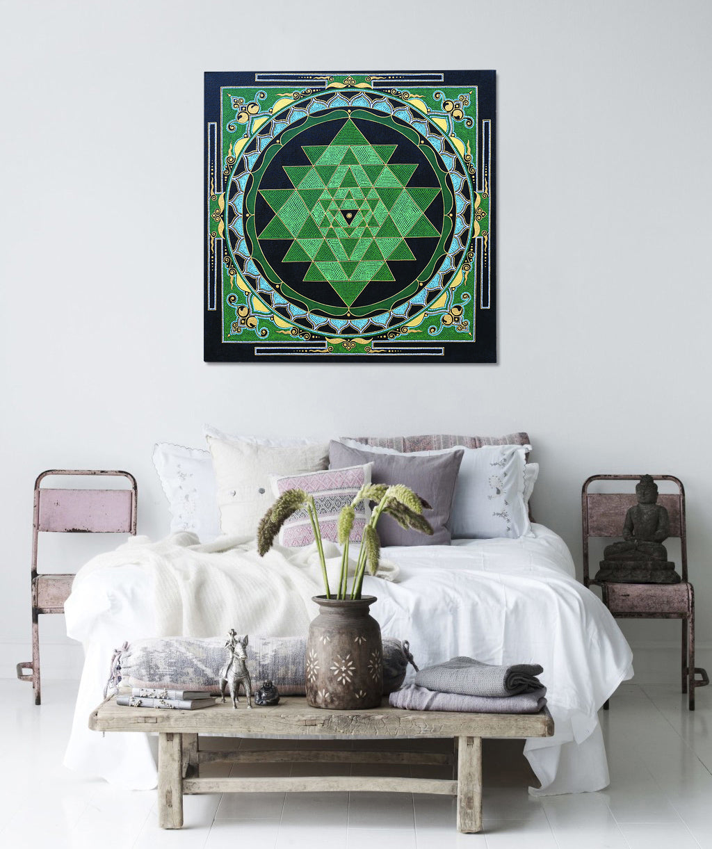 Sri Yantra painting, hanging on a wall above a boho bed in a bedroom. Green and gold colors. 60x60 cm (24×24 inches) size.