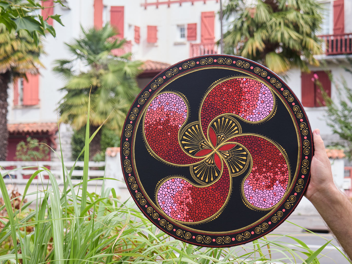 Original pointillism painting of the Lauburu Basque cross, round 40cm canvas. Basque style houses on the background