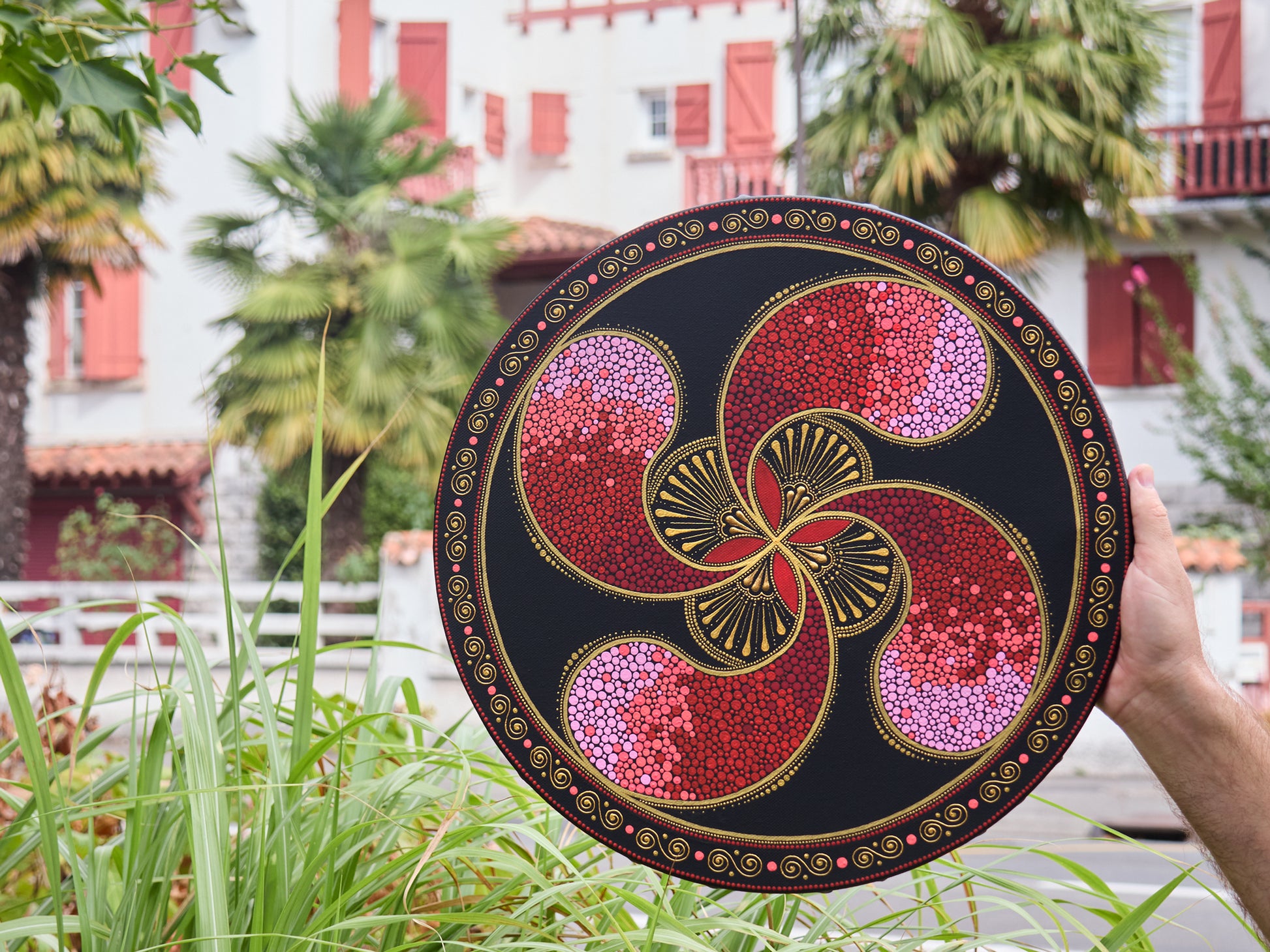Original pointillism painting of the Lauburu Basque cross, round 40cm canvas. Basque style houses on the background