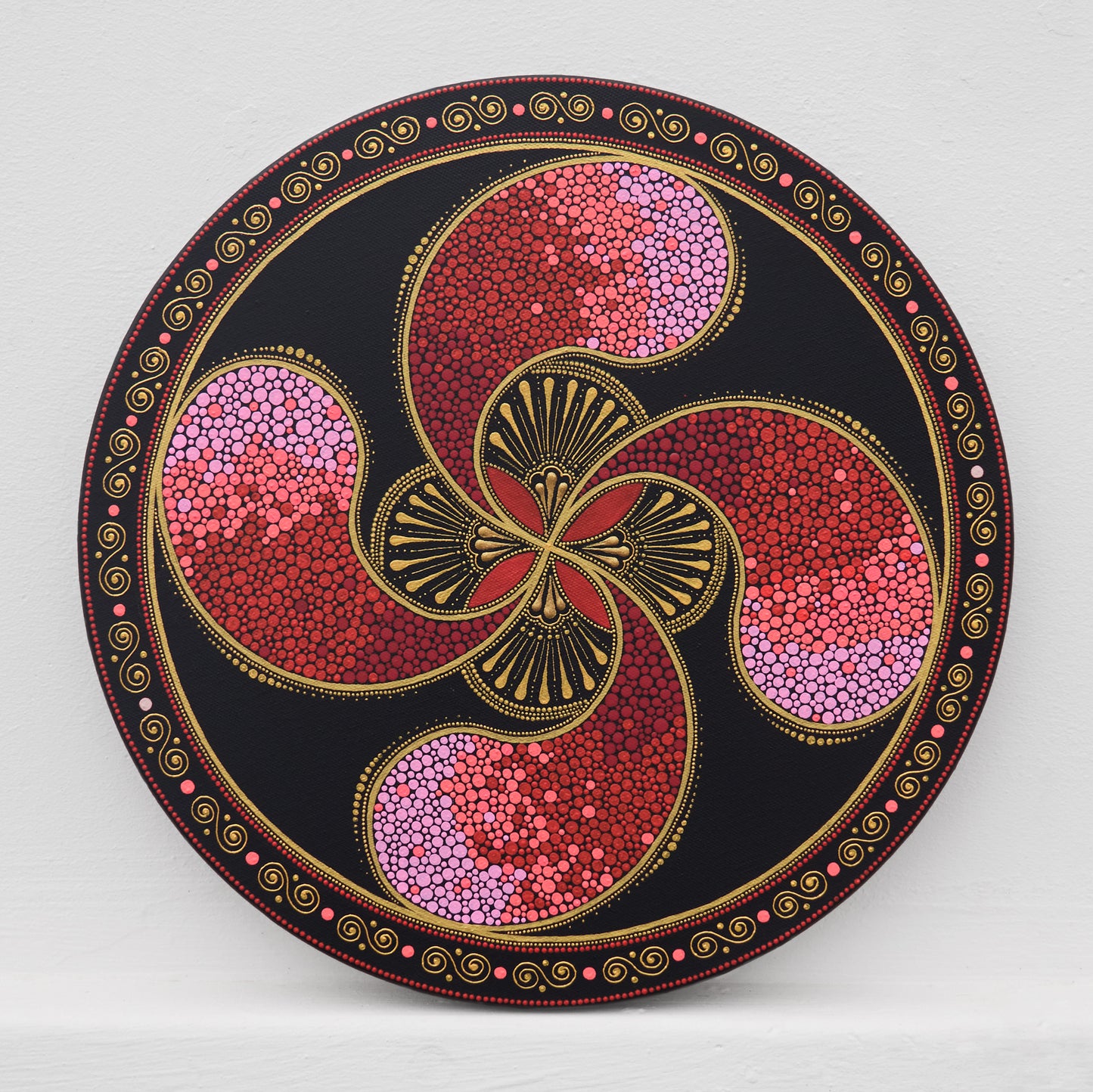 Round Lauburu Basque cross painting in pointillism, red acrylic on 40cm canvas.