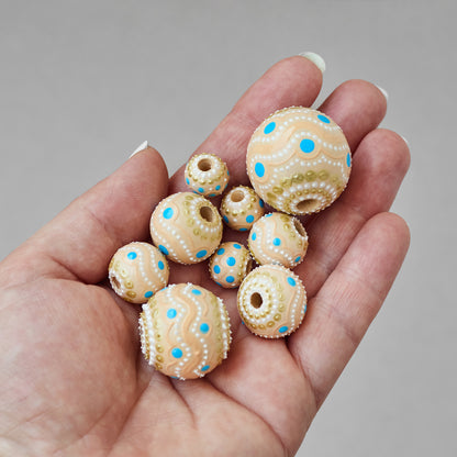 Wooden beads in a hand, different sizes, hand-painted beige boho beads