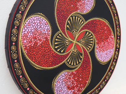 Round Lauburu Basque cross painting in pointillism, red and gold toones, detailed close-up view.