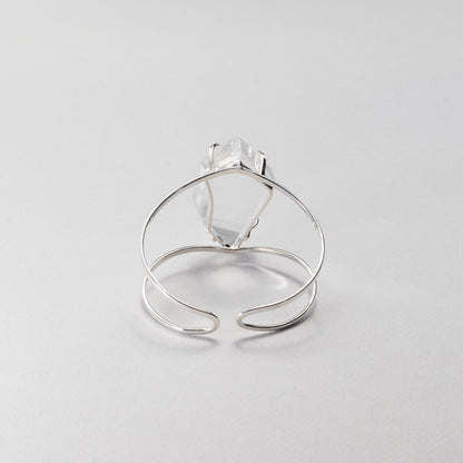 Silver bracelet, view from the back, on a light gray background