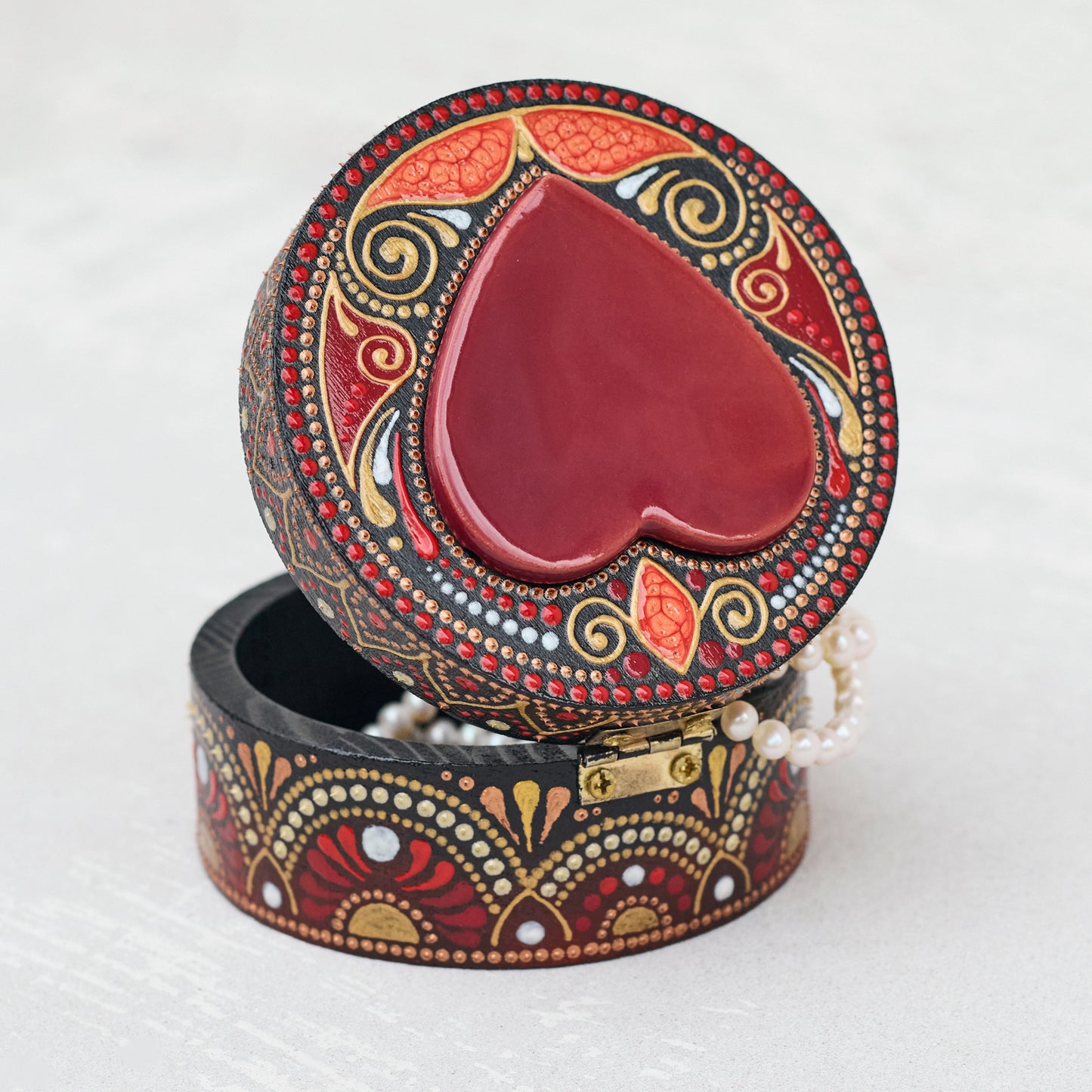 Decorative jewelry box with a red heart on a white background