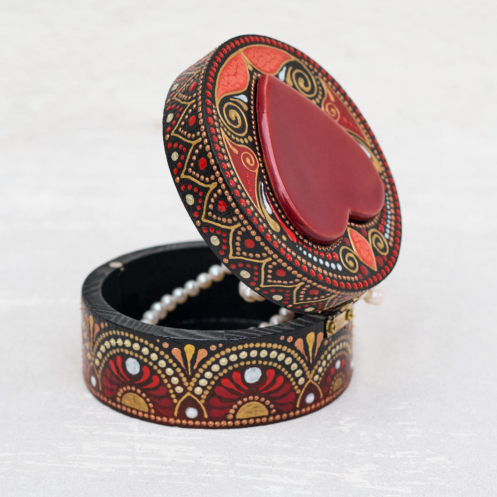 Decorative jewelry box with intricate patterns on a white background