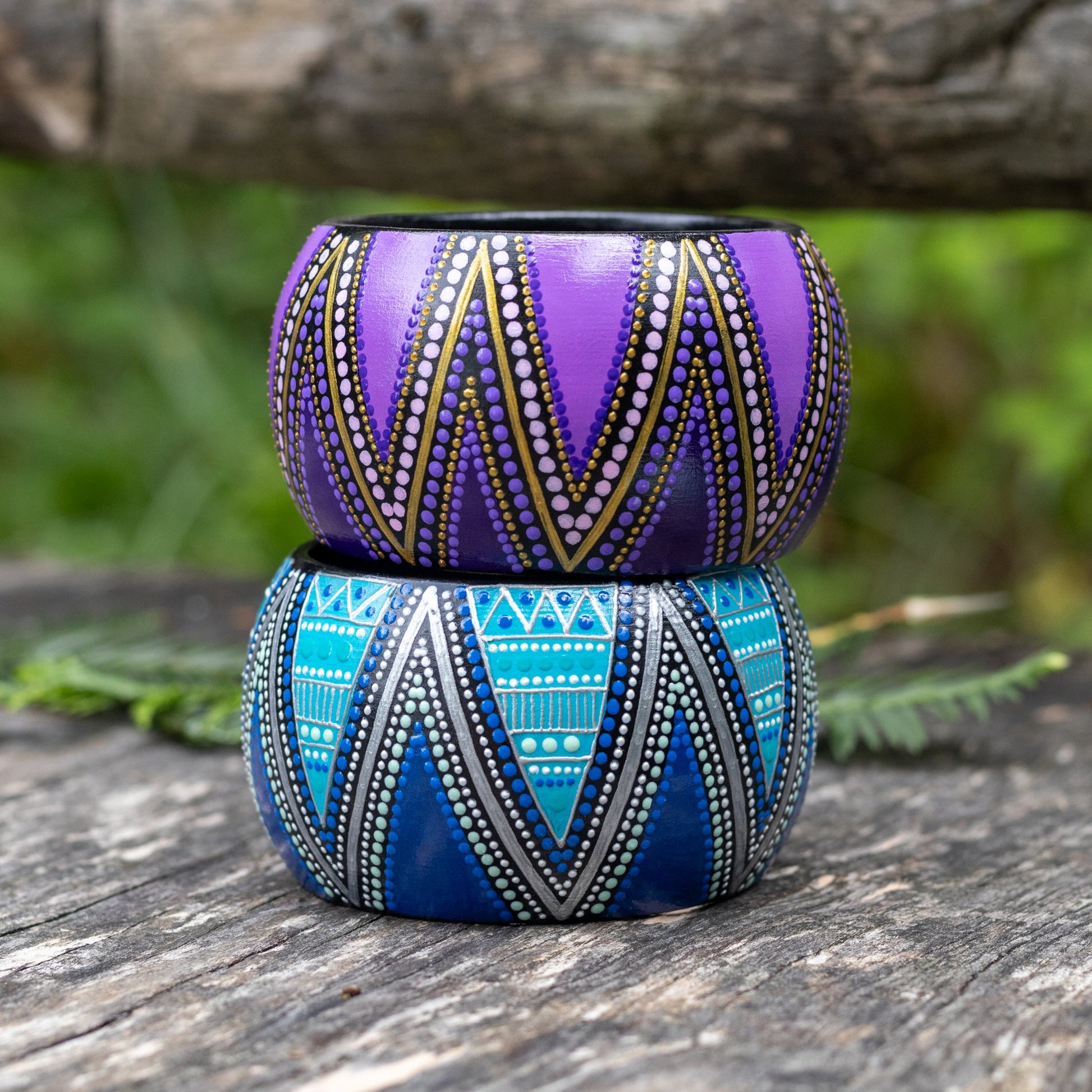 two wooden bracelets, hand painted in purple and blue